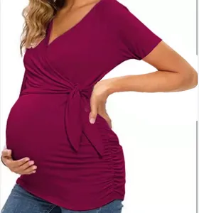 Close-up of wine red V-neck nursing t-shirt with elegant wrap-around side tie detail