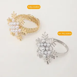 Detailed macro shot of snowflake napkin rings in gold and silver with pearl accents