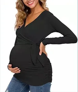 Side detail of a black V-neck maternity nursing top with wrap tie and long sleeves