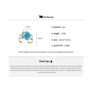 Blue enamel flower bangle with gold finish including material and size specifications