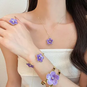 Macro view of purple oil-dripping flower jewelry set featuring necklace, ring and bracelets