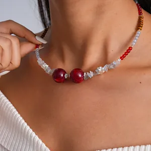 Close-up detail of retro glass beaded choker necklace with red swirl beads worn by model