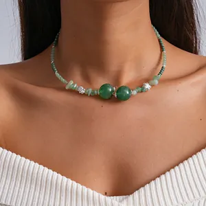 Close-up detail of retro green blooming glass beaded choker necklace worn on person's neck