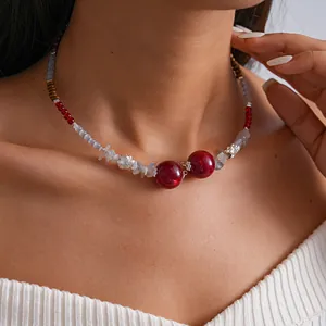 Close-up detail of a retro acrylic dyed glass beaded collar necklace worn by a model