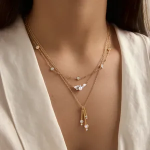 Detail of gold-plated titanium steel layered necklace with pearls and zircons