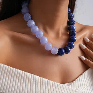 Detalle de cuentas de acrílico de gran tamaño con degradado en tonos púrpura y azul.