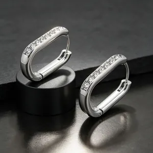 Detailed close-up view of silver U-shaped stainless steel hoop earrings with clear stones