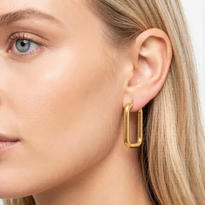 Close-up of a stylish gold-plated U-shaped stainless steel rectangular hoop earring on model