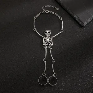 Detailed view of vintage gothic skeleton slave bracelet with ring set in silver tone