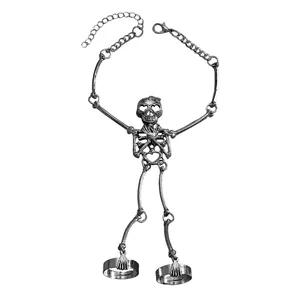Close-up of gothic skeleton hand harness with skull and rings in vintage silver