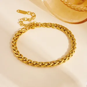 Close-up of golden braided wheat chain bracelet in durable stainless steel finish