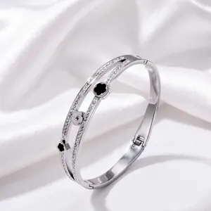 Detailed view of silver stainless steel clover bangle with dimensions and weight info