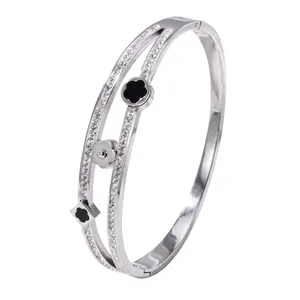 Elegant double-band stainless steel bangle with lucky four-leaf clover charms and crystals