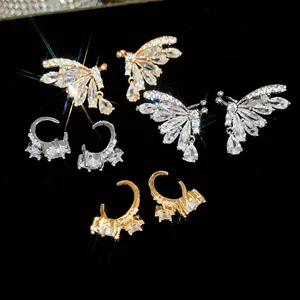Elegant 18k gold plated butterfly and teardrop zirconia ear clips set on black background