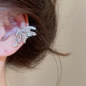 Close-up of elegant 18k gold plated zircon butterfly wing ear cuff worn on the ear