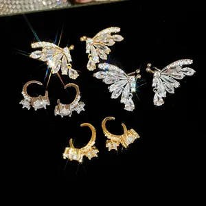 Detailed view of 18k gold plated butterfly and teardrop zircon ear clips with sparkling effects