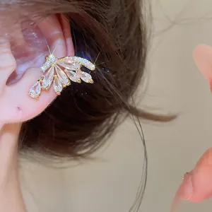 Detailed macro view of 18k gold plated butterfly wing ear cuff with sparkling zircon drops