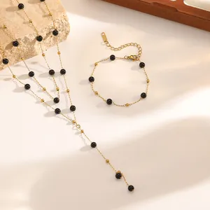Detailed view of titanium steel Y-shape necklace and bracelet set with black beads
