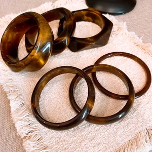 Close-up of vintage tortoiseshell resin geometric bracelets with elegant marble patterns