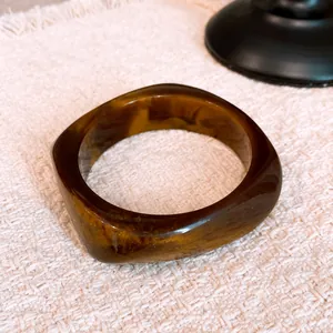 Close-up detail of retro tortoiseshell pattern on a stylish geometric resin bangle bracelet.