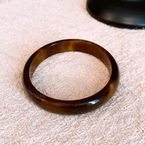 Detailed macro view of a vintage resin bangle with a brown tortoiseshell marble pattern