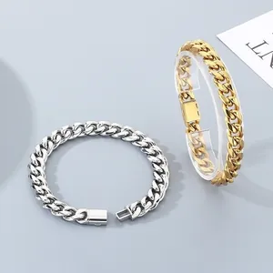 Polished stainless steel Cuban link chain bracelets in silver and gold with fold-over clasp.