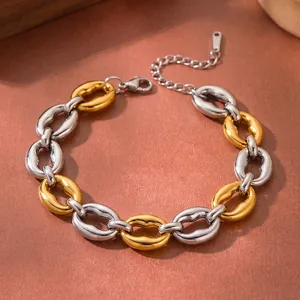 Close-up of two-tone gold and silver stainless steel chunky chain bracelet with geometric links