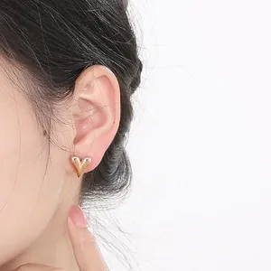 Elegant minimalist 18k gold plated stainless steel heart stud earrings for women worn on ear
