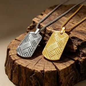 Close-up of gold and silver titanium steel dog tag pendants with a textured diagonal line pattern