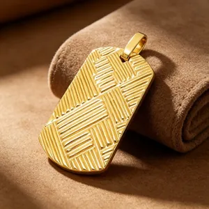Close-up of gold-plated titanium steel dog tag pendant with 3D crisscross texture.