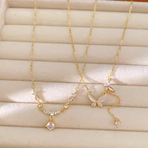 Close-up of 18k gold plated necklaces with round cubic zirconia and butterfly motifs