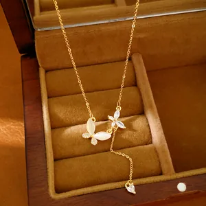 Macro detail of 18k gold-plated butterfly necklace with sparkling zircon stones