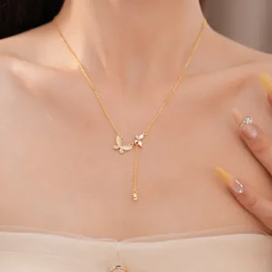 Close-up of 18k gold plated butterfly necklace with zircon stones on model's neck