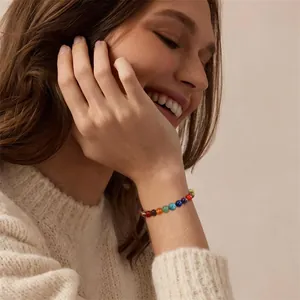 Model wearing 8mm healing gemstone chakra beaded bracelet with tiger eye stones