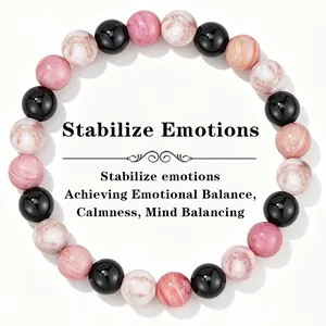 Detail of 8mm pink and black beaded healing crystal bracelet for emotional balance