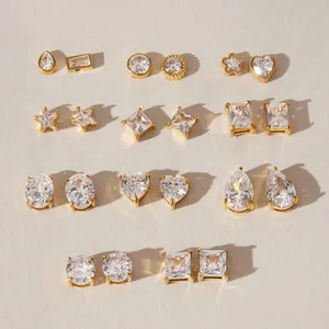 Detail view of multiple gold-plated stainless steel stud earrings with clear zircon.