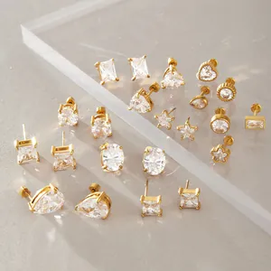 Detailed view of various gold-tone stainless steel earrings with sparkling cubic zirconia stones.