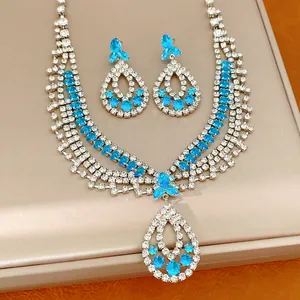 Detailaufnahme von luxuriöser Halskette im Royal-Stil und blauen Tropfenohrringen