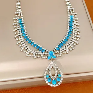 Elegante mehrlagige Silberkette mit funkelnden blauen Strasssteinen und Tropfenanhänger