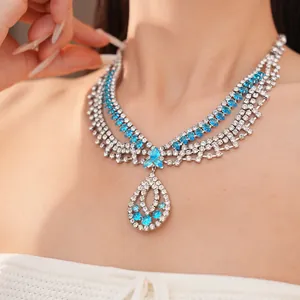 Nahaufnahme einer luxuriösen mehrlagigen Strasshalskette mit einem blauen Tropfenanhänger