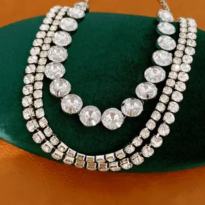 Detailed macro shot of a triple-layer silver necklace set with brilliant round rhinestones