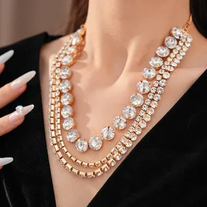 Detailed close-up of a glamorous multi-layered gold necklace with sparkling round rhinestones