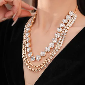 Close-up of a luxurious multi-layer gold necklace with sparkling round rhinestones