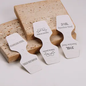 Detailed view of white folding cardstock jewelry display cards with stainless steel prints