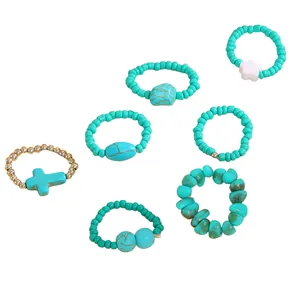 7-piece Bohemian turquoise beaded ring set featuring cross and flower charms for women