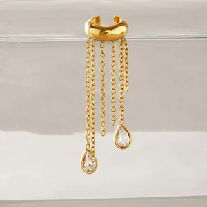 Close-up of gold stainless steel ear cuff with dangling tassel chains and teardrop stones