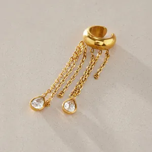 Close-up detail of a gold stainless steel tassel ear cuff with pear-shaped crystals