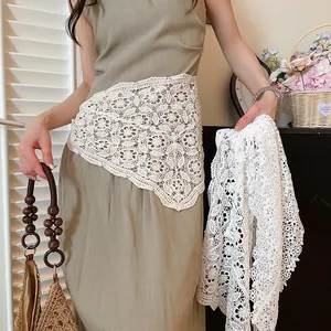 Detailed view of white crochet lace triangular waist scarf fashion accessory for layering
