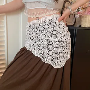 Detailed macro view of a white hollow-out crochet lace triangular waist scarf decor.
