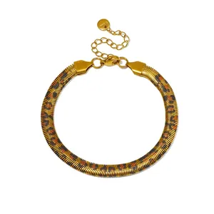 Detailed view of the leopard print pattern on a gold stainless steel blade chain bracelet.